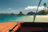 Passenger view from the Seatours speedboat bow deck with leather seating and limestone islands ahead, El Nido Palawan