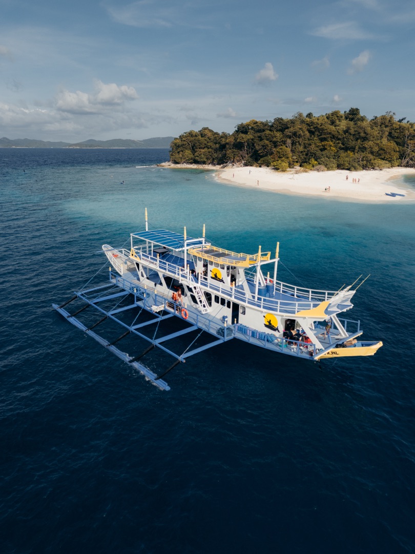 Aerial view of turquoise lagoon and limestone cliffs in El Nido, Palawan