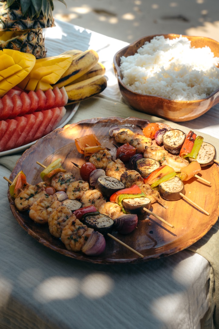 Private island lunch — grilled prawn skewers, vegetables, rice and tropical fruit